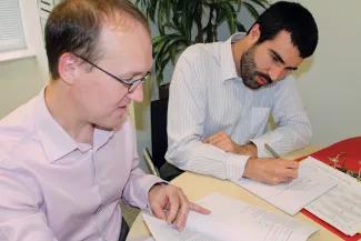 Staff looking at reports and having a meeting