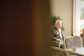 Elderly man sitting on his own