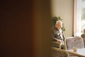 Elderly man sitting on his own