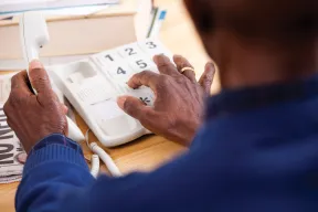 Woman dialing on telephone